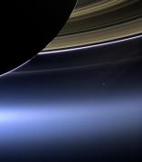 Rare NASA photo of Saturn in which Earth can be seen as a tiny blue dot just right of center, taken July 19, 2013